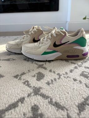 Nike Cream Sneakers with Black Swoosh, Green & Purple Accents